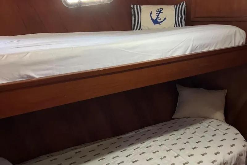  Yacht Photos Pics 1987 DeFever Tri-Cabin interior with wooden bunk beds and nautical-themed decor.