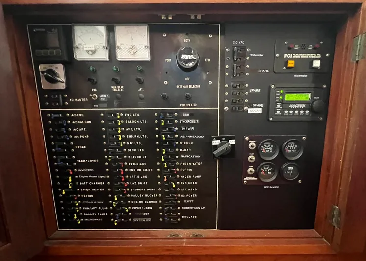  Yacht Photos Pics Electrical control panel of a 1987 DeFever Tri-Cabin boat, featuring various switches and gauges.