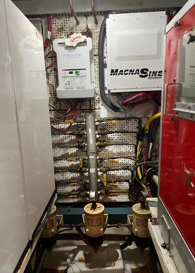  Yacht Photos Pics Engine room of 1987 DeFever Tri-Cabin with electrical panels and fuel filters.