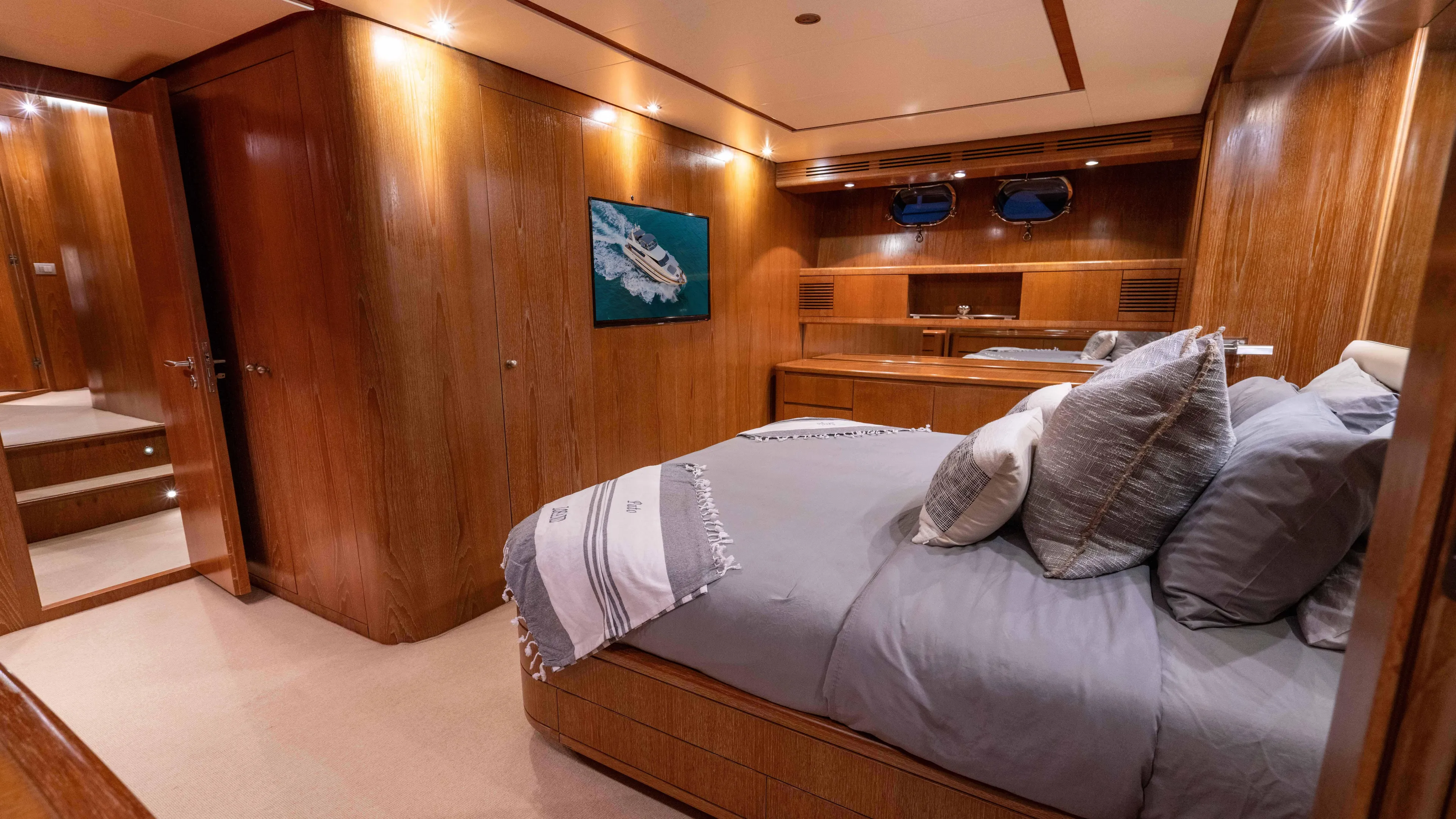 Losand Yacht Photos Pics Luxurious bedroom interior of 2005 Sanlorenzo SL82 yacht with wood paneling and cozy bedding.