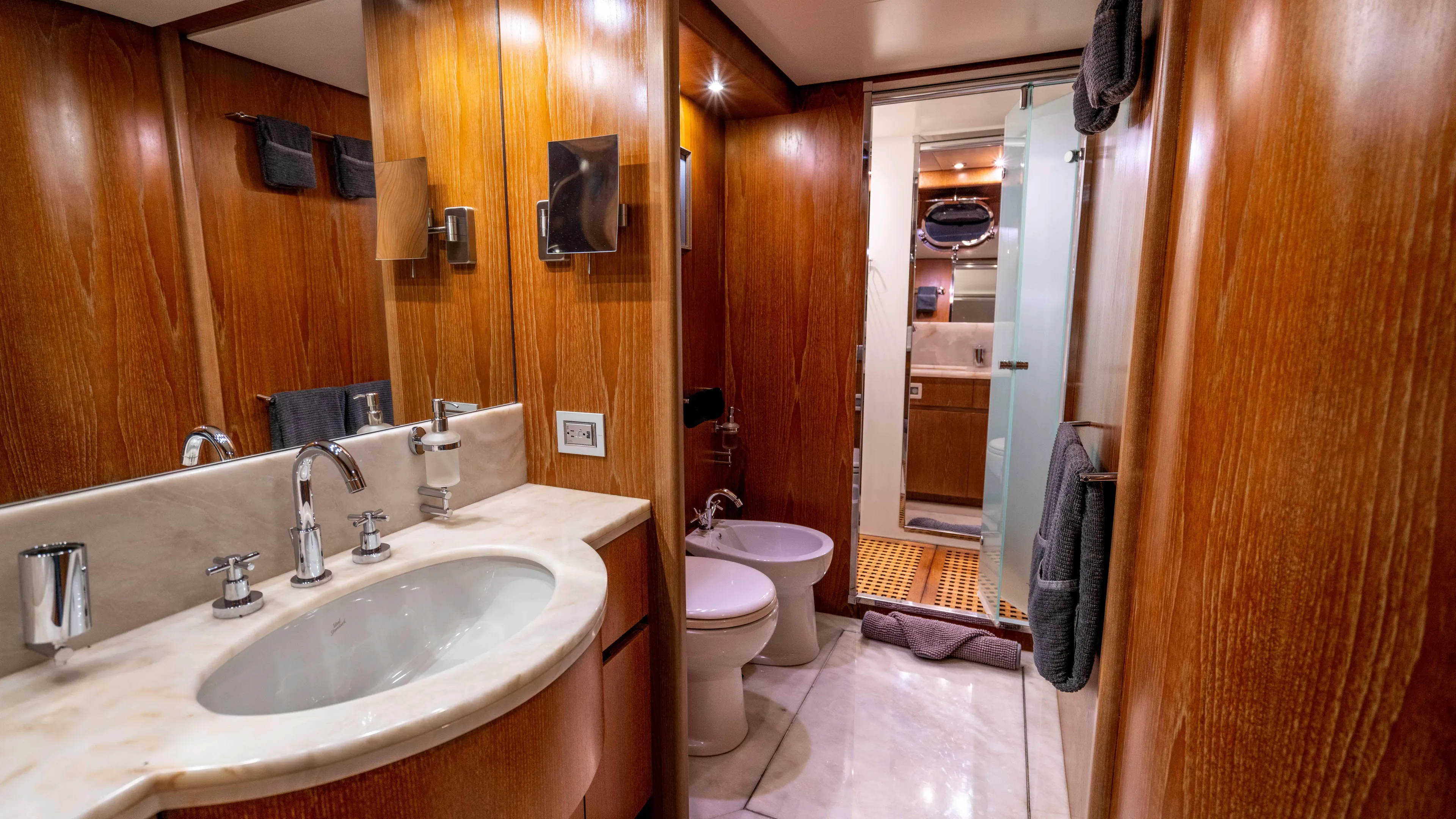 Losand Yacht Photos Pics Luxurious bathroom on 2005 Sanlorenzo SL82 yacht with wood paneling and modern fixtures.