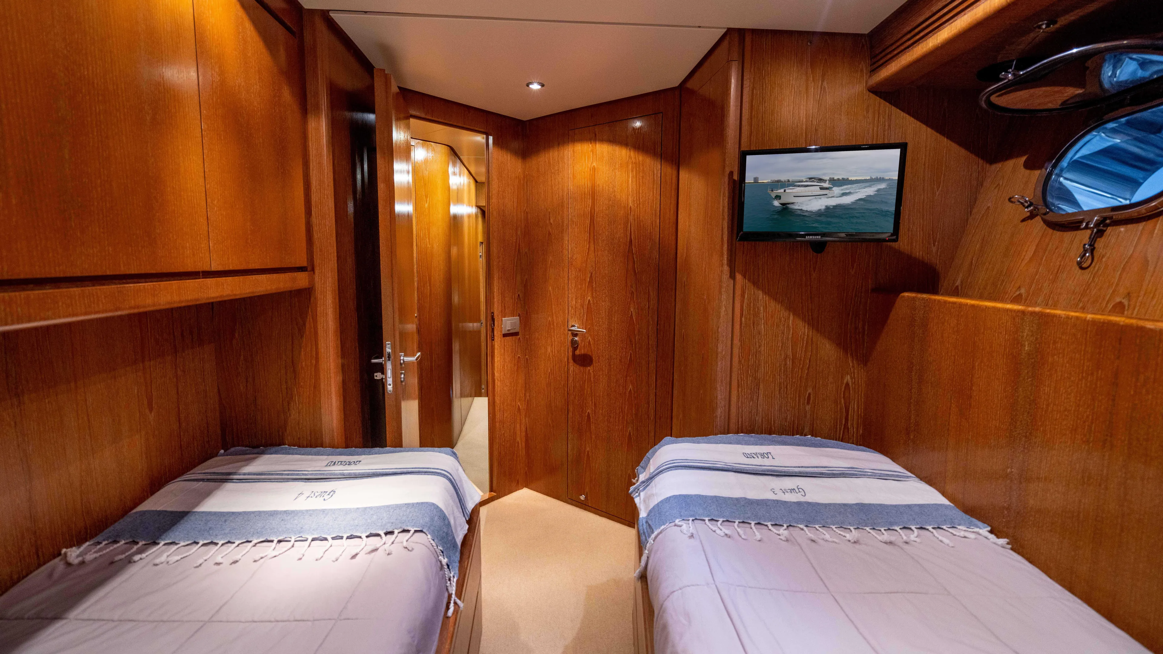 Losand Yacht Photos Pics Luxurious 2005 Sanlorenzo SL82 yacht cabin with twin beds and wooden interior.