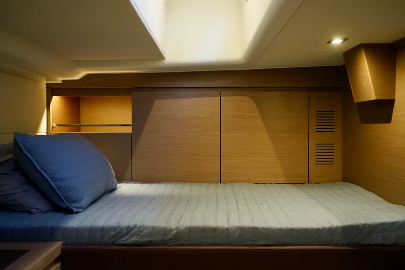  Yacht Photos Pics Luxurious cabin interior of 2025 Pardo Yachts P43 with cozy bedding and wooden accents.