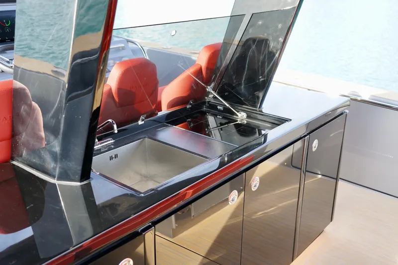  Yacht Photos Pics Modern kitchen area on 2025 Pardo Yachts P43 with sleek black cabinetry and red seating.