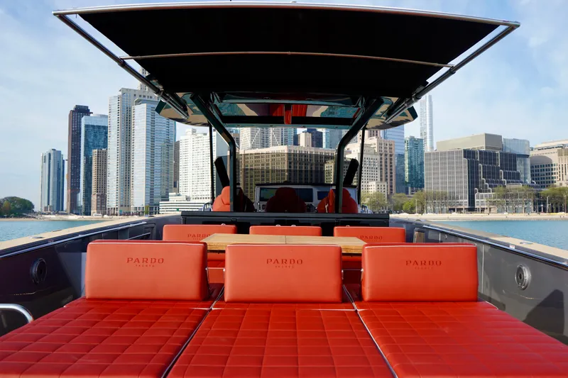  Yacht Photos Pics 2025 Pardo Yachts P43 with red seating, city skyline in background.