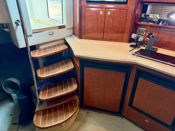 Great Escape Yacht Photos Pics Interior of 2004 Sea Ray 390 Sundancer with wooden stairs and cabinetry.