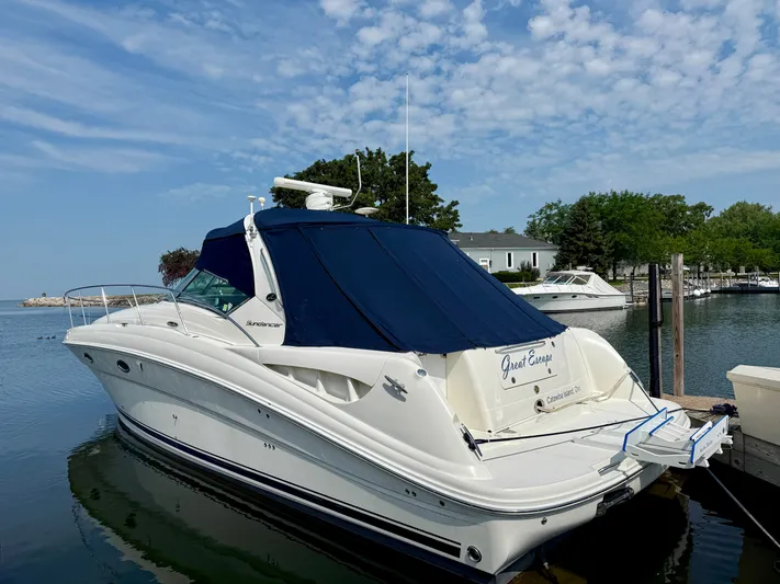 Great Escape Yacht Photos Pics 2004 Sea Ray 390 Sundancer yacht docked in a serene marina setting.