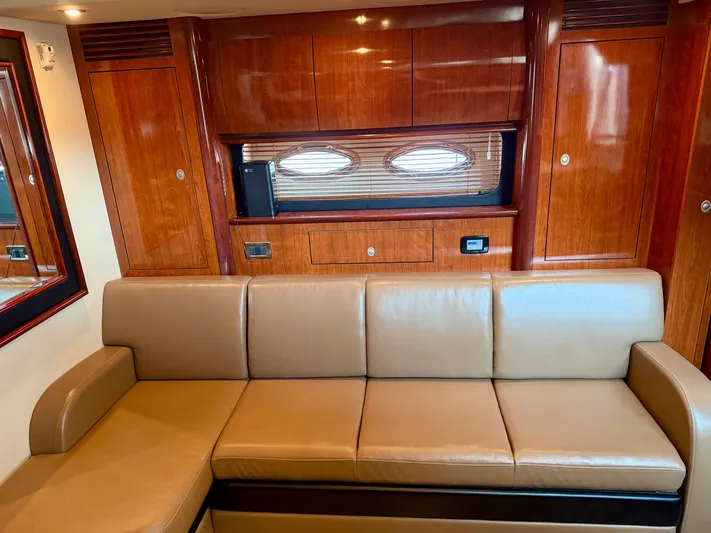Great Escape Yacht Photos Pics Luxurious interior of 2004 Sea Ray 390 Sundancer with leather seating and wooden cabinetry.