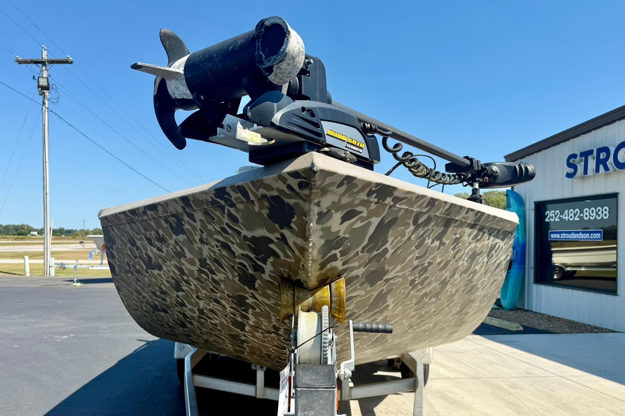 2019 Excel 230 Bay Pro boat with camouflage design on a trailer.