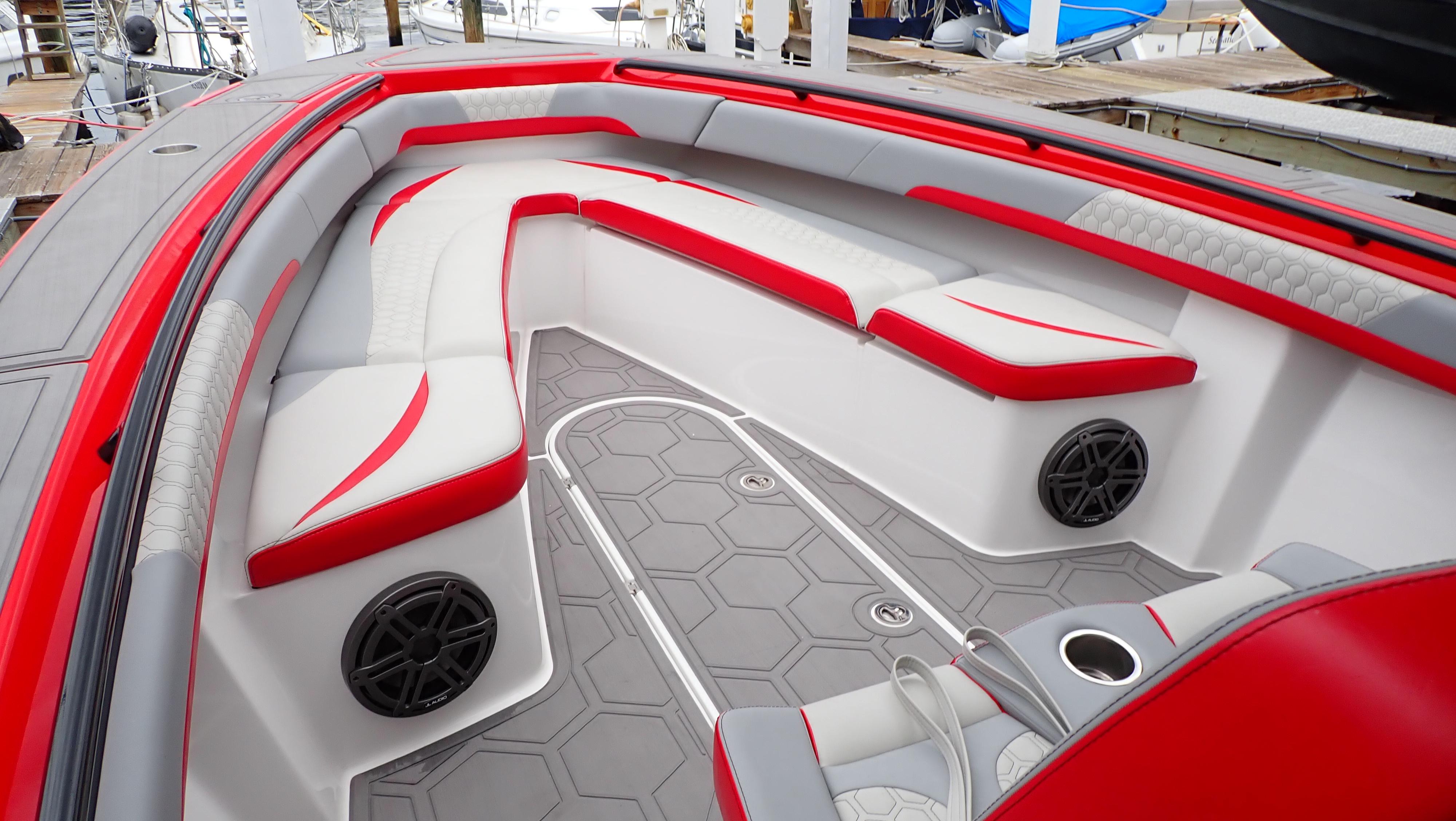 2024 Statement 350 Open boat interior with red and white seating, hexagonal flooring, and speakers.