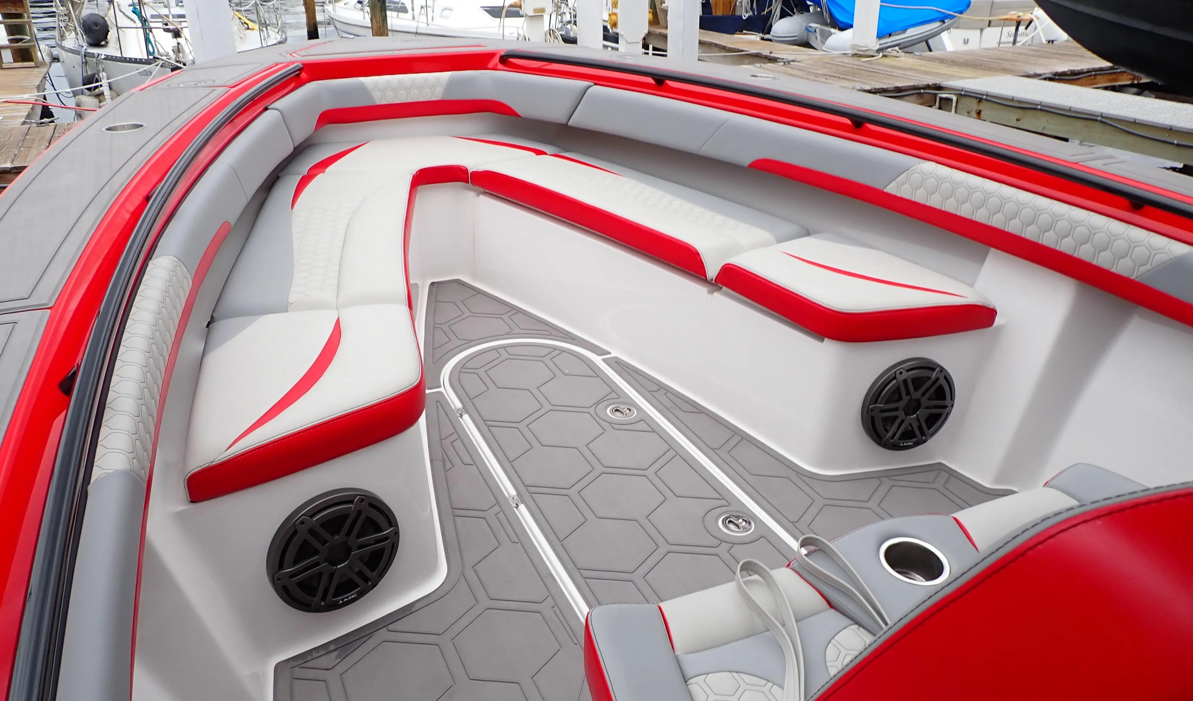 2024 Statement 350 Open boat interior with red and white seating, hexagonal flooring, and speakers.