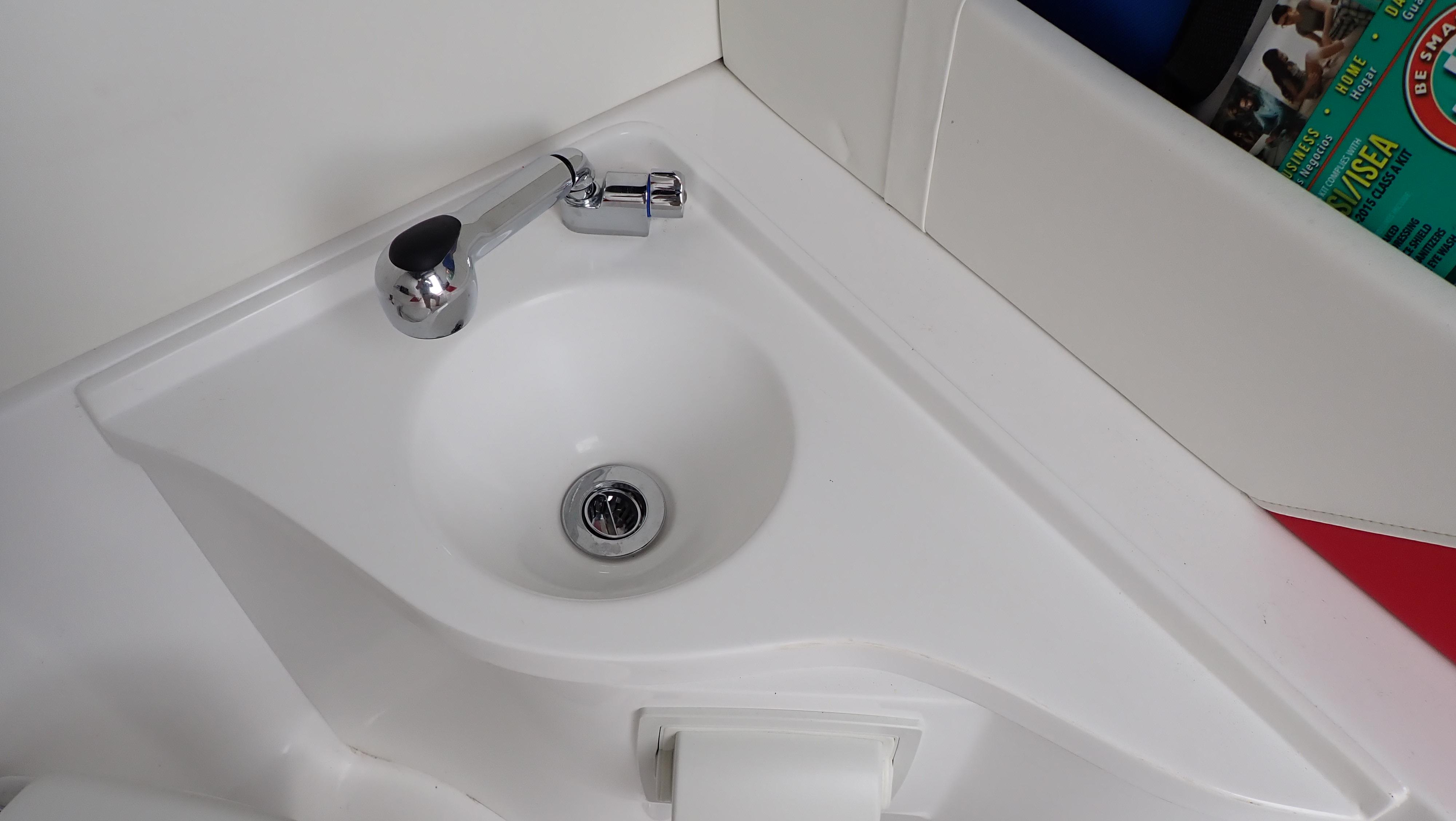 Compact white sink with chrome faucet in 2024 Statement 350 Open boat.