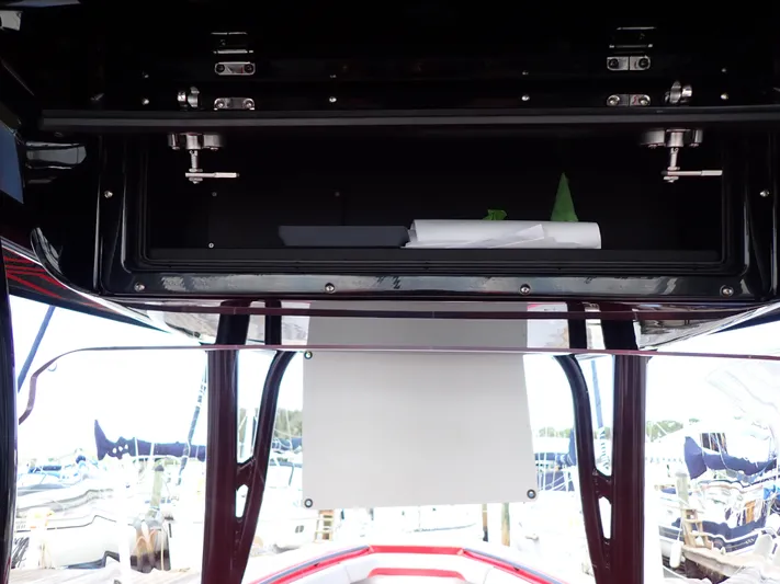  Yacht Photos Pics 2024 Statement 350 Open boat interior with storage compartment and marina view.