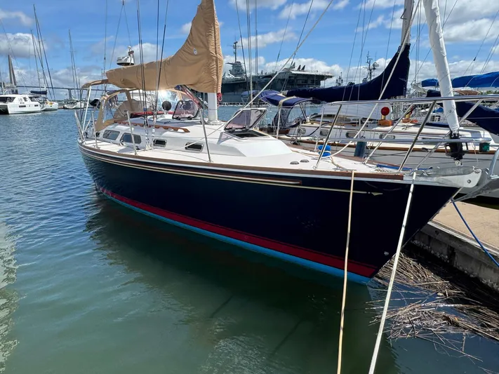 Delta Sand Yacht Photos Pics Sailboat docked in marina, Sabre 362, 2000 model, with tan sails and blue hull.