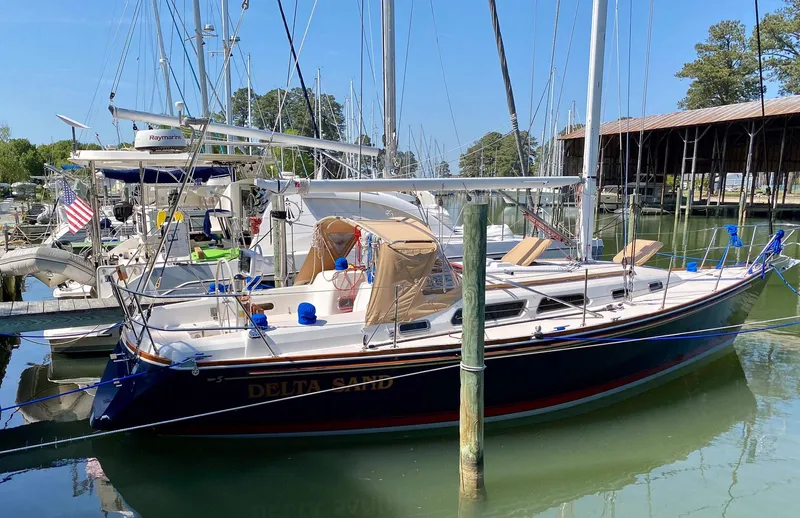Delta Sand Yacht Photos Pics 2000 Sabre 362 sailboat docked in a marina, surrounded by other boats.
