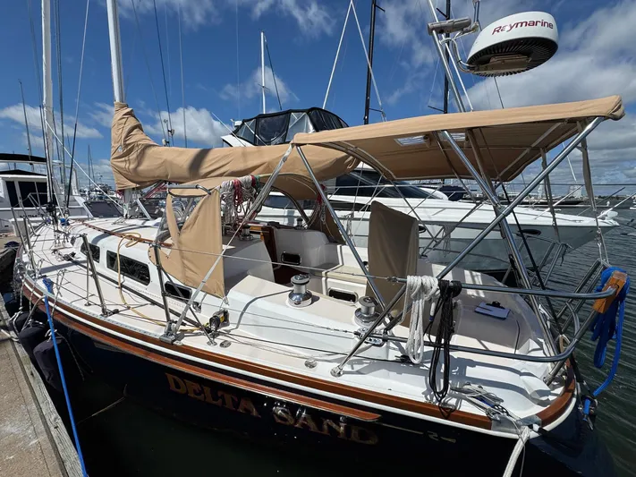 Delta Sand Yacht Photos Pics 2000 Sabre 362 sailboat docked, featuring tan canvas covers and Raymarine equipment.