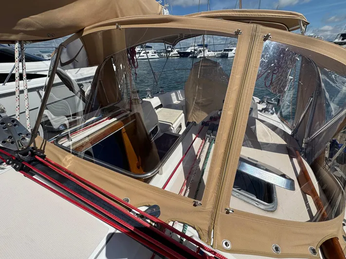 Delta Sand Yacht Photos Pics 2000 Sabre 362 sailboat cockpit with tan canvas cover and marina view.