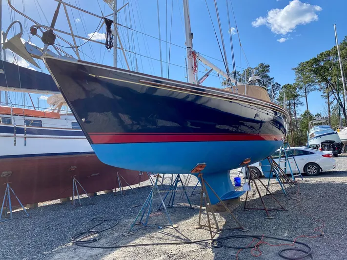 Delta Sand Yacht Photos Pics Sailboat on stands, Sabre 362 model, 2000, in a boatyard under clear blue sky.