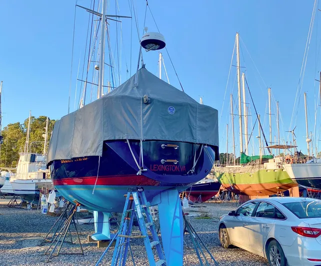 Delta Sand Yacht Photos Pics Sailboat Sabre 362, 2000 model, covered and docked in a boatyard with other vessels.