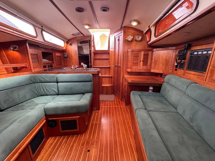 Delta Sand Yacht Photos Pics Luxurious interior of 2000 Sabre 362 sailboat with plush seating and wooden finishes.