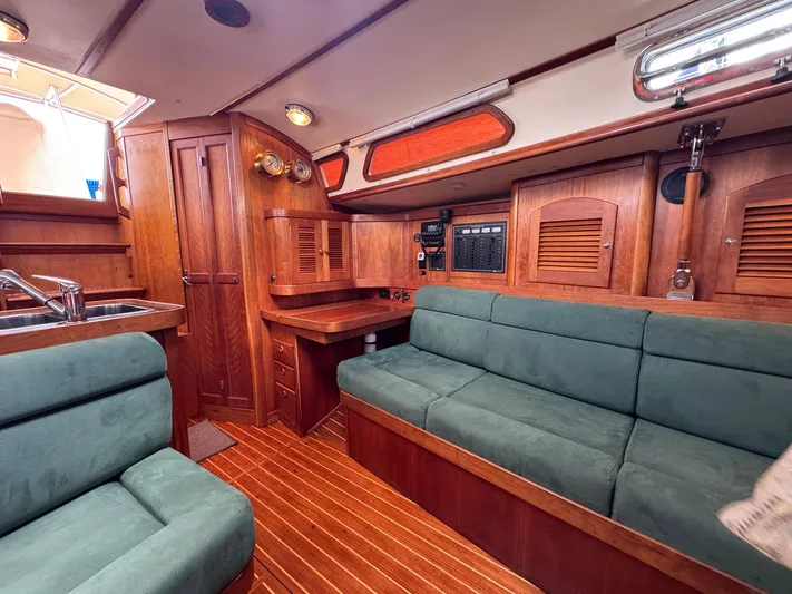 Delta Sand Yacht Photos Pics Interior of 2000 Sabre 362 sailboat with wood finish and green upholstery.