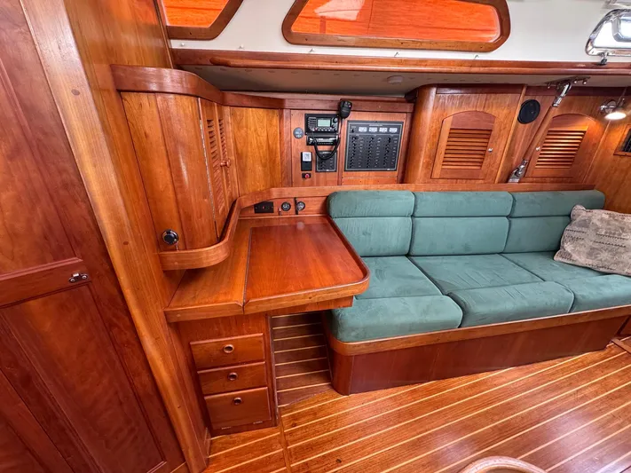 Delta Sand Yacht Photos Pics Interior of 2000 Sabre 362 yacht with wooden cabinetry and green cushioned seating.