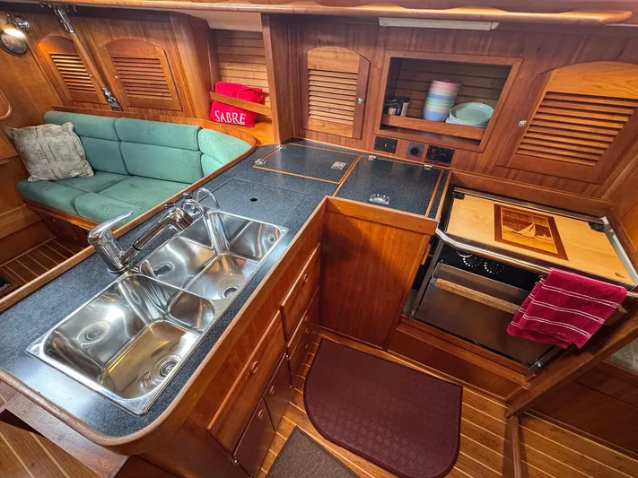 Delta Sand Yacht Photos Pics Interior of 2000 Sabre 362 yacht with kitchen and seating area.