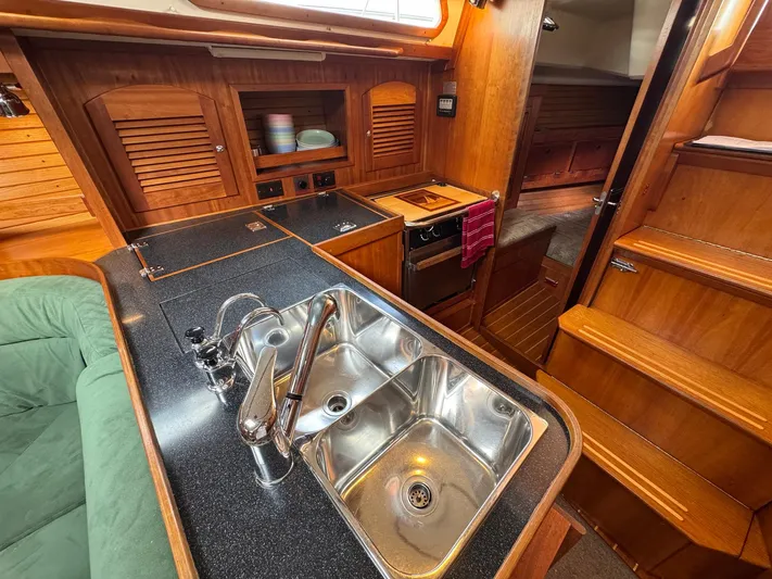 Delta Sand Yacht Photos Pics Interior of 2000 Sabre 362 yacht showing kitchen sink and wooden cabinetry.