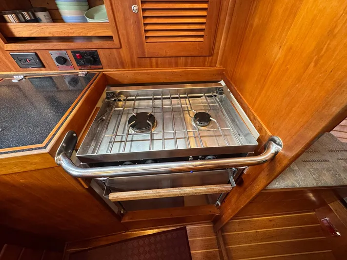 Delta Sand Yacht Photos Pics Compact kitchen area with a two-burner stove on a 2000 Sabre 362 yacht.