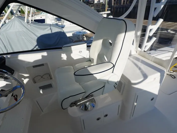  Yacht Photos Pics 2024 Albemarle 30 Express boat interior with white captain's chair and sleek design.