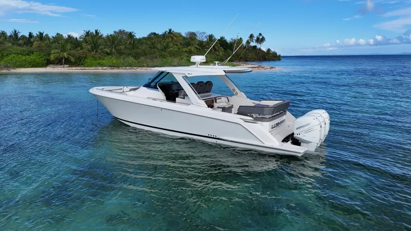  Yacht Photos Pics 2020 Tiara Yachts 38 LS in clear tropical waters near lush island.