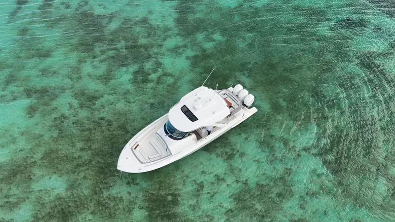  Yacht Photos Pics Aerial view of 2020 Tiara Yachts 38 LS on clear turquoise water.