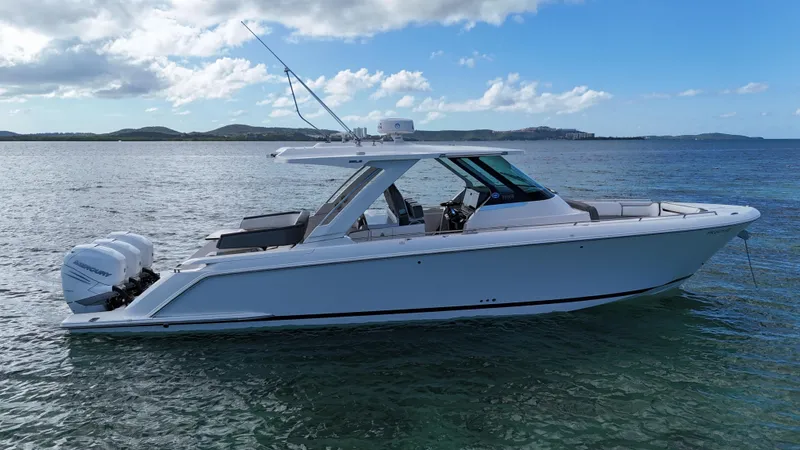 Yacht Photos Pics 2020 Tiara Yachts 38 LS boat on calm water under a blue sky.