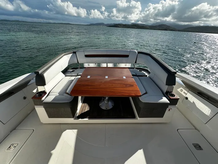  Yacht Photos Pics 2020 Tiara Yachts 38 LS boat with elegant seating and wooden table on open water.