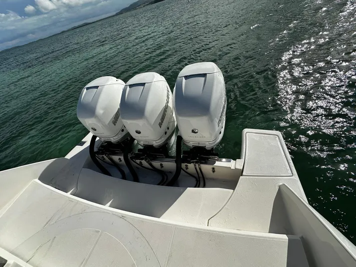  Yacht Photos Pics 2020 Tiara Yachts 38 LS with triple outboard engines on open water.