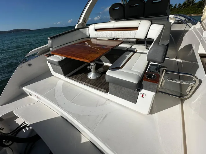  Yacht Photos Pics 2020 Tiara Yachts 38 LS luxury seating area with wooden table on deck.