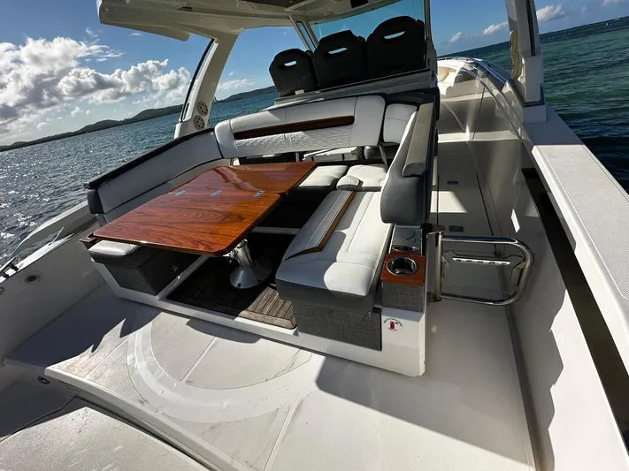  Yacht Photos Pics 2020 Tiara Yachts 38 LS with luxurious seating and wooden table on open water.