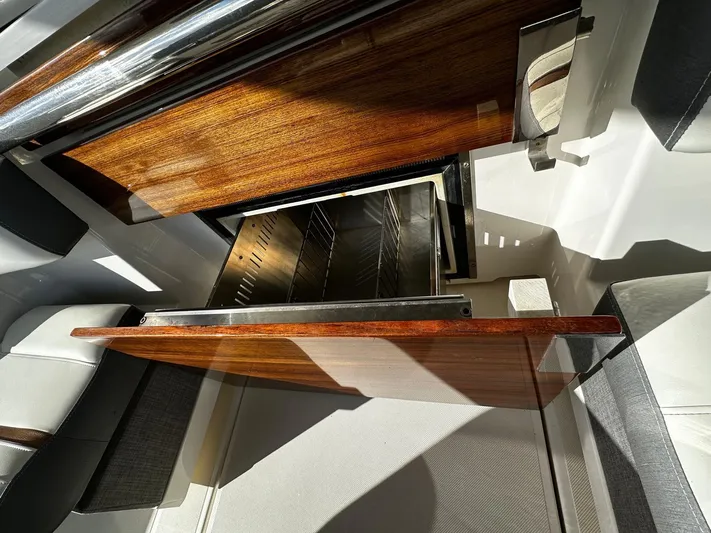  Yacht Photos Pics 2020 Tiara Yachts 38 LS interior with open wooden cabinet and stainless steel drawer.