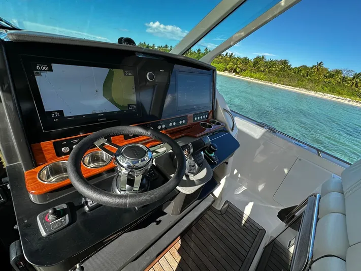  Yacht Photos Pics Cockpit of 2020 Tiara Yachts 38 LS with dual screens, steering wheel, and ocean view.