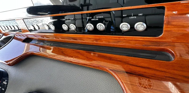  Yacht Photos Pics Dashboard of 2020 Tiara Yachts 38 LS with sleek wood finish and control buttons.