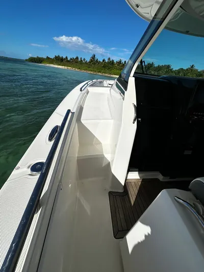  Yacht Photos Pics 2020 Tiara Yachts 38 LS boat on water near tropical shoreline.