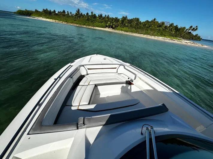  Yacht Photos Pics 2020 Tiara Yachts 38 LS boat near tropical island, clear blue water.