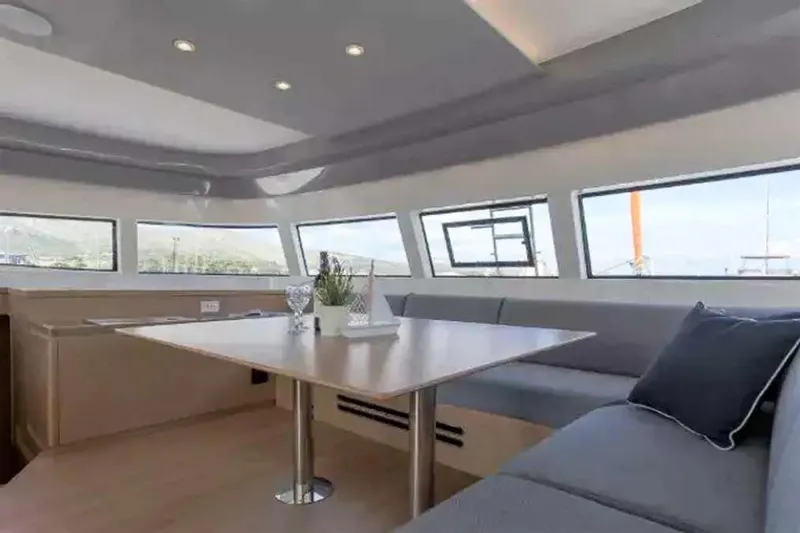  Yacht Photos Pics Modern interior of 2023 Excess 15 yacht with sleek seating and large windows.