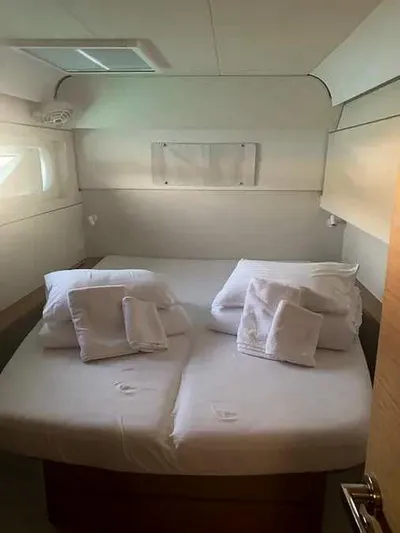  Yacht Photos Pics Cozy cabin interior of 2023 Excess 15 yacht with neatly arranged bedding.