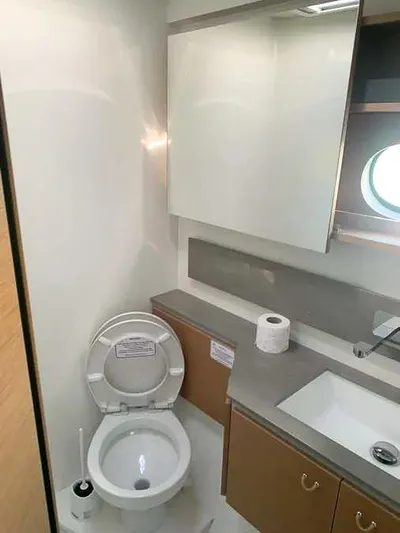  Yacht Photos Pics Modern bathroom in 2023 Excess 15 yacht with toilet, sink, and porthole window.