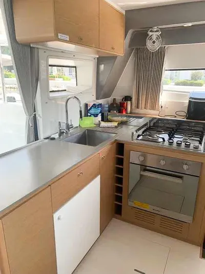  Yacht Photos Pics Modern kitchen in 2023 Excess 15 yacht with stove, sink, and wooden cabinets.