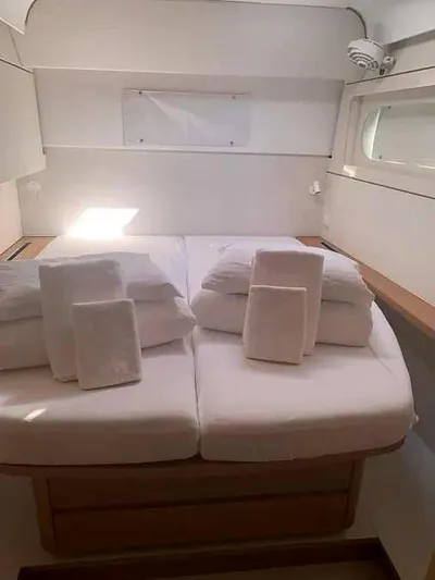  Yacht Photos Pics Luxurious cabin interior of 2023 Excess 15 yacht with neatly arranged bedding.