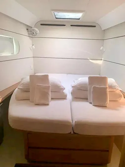  Yacht Photos Pics Luxurious cabin interior of 2023 Excess 15 yacht with neatly arranged bedding.