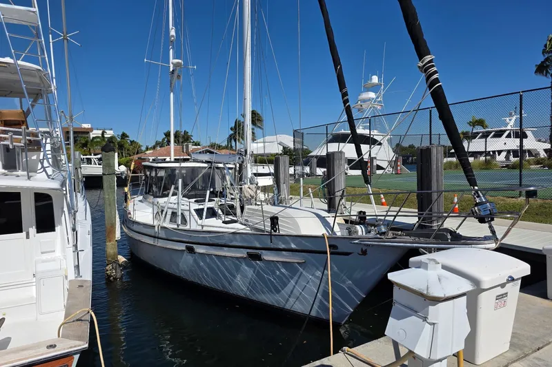 At Last Yacht Photos Pics 1982 Irwin 52 sailboat docked at marina under clear blue sky.