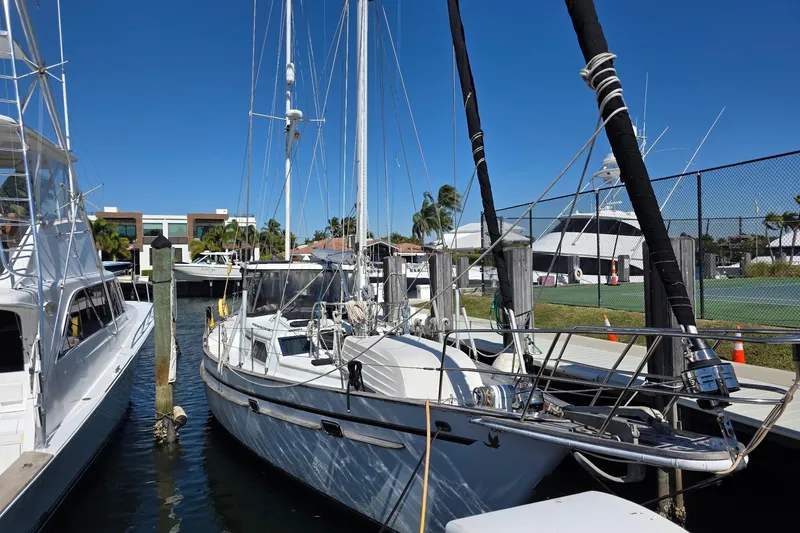 At Last Yacht Photos Pics 1982 Irwin 52 sailboat docked at marina under clear blue sky.
